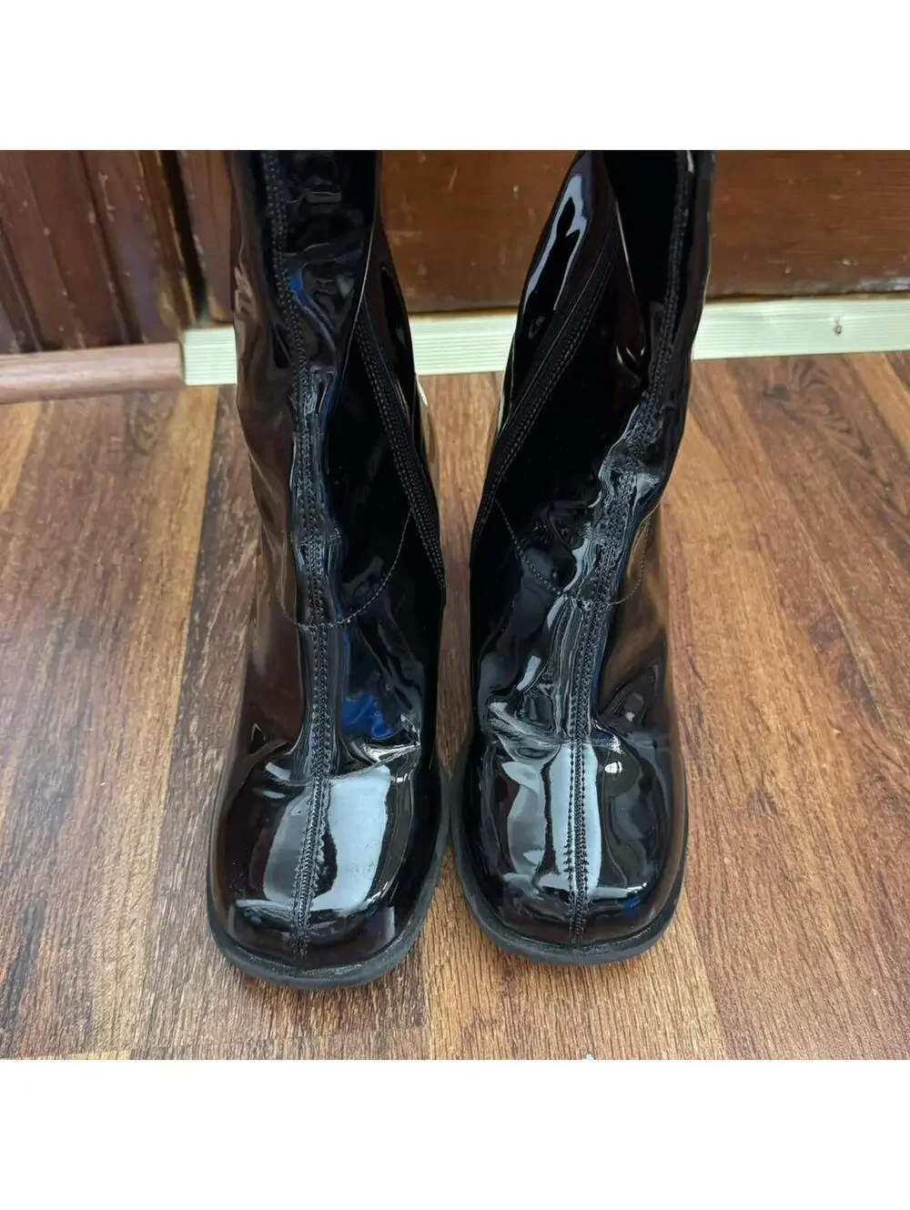 Black knee-high/go go boots with a 4” heel